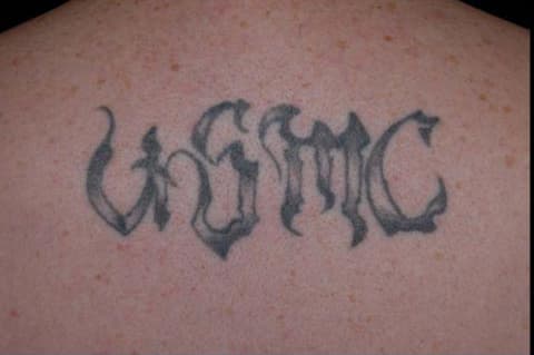 A back with heavy black lettering, cleared to faint shadowing, before