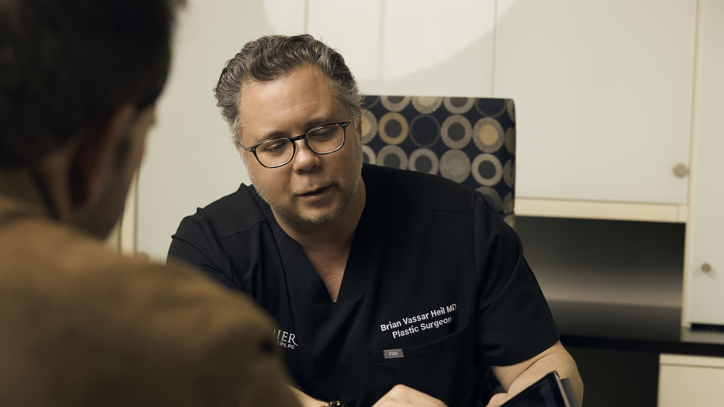 Dr. Heil speaking with a patient during a consultation