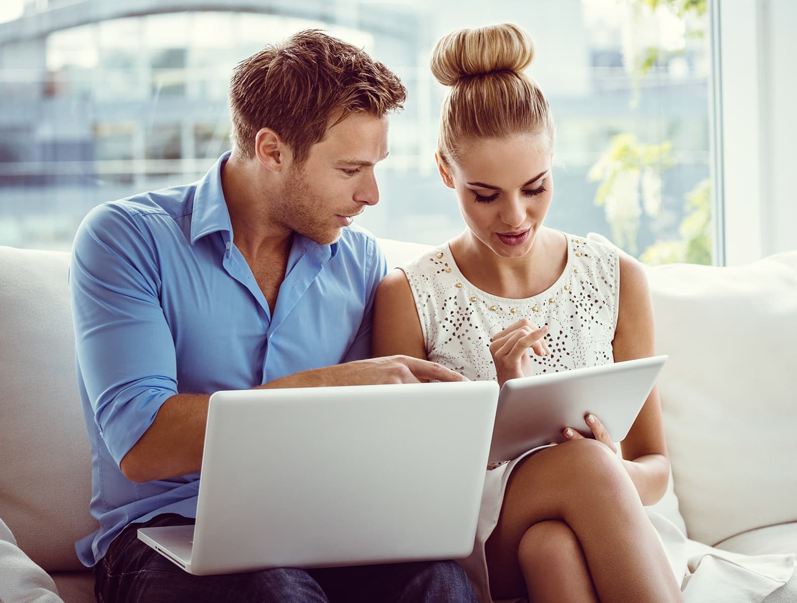 A couple reviewing a financing application together on a laptop