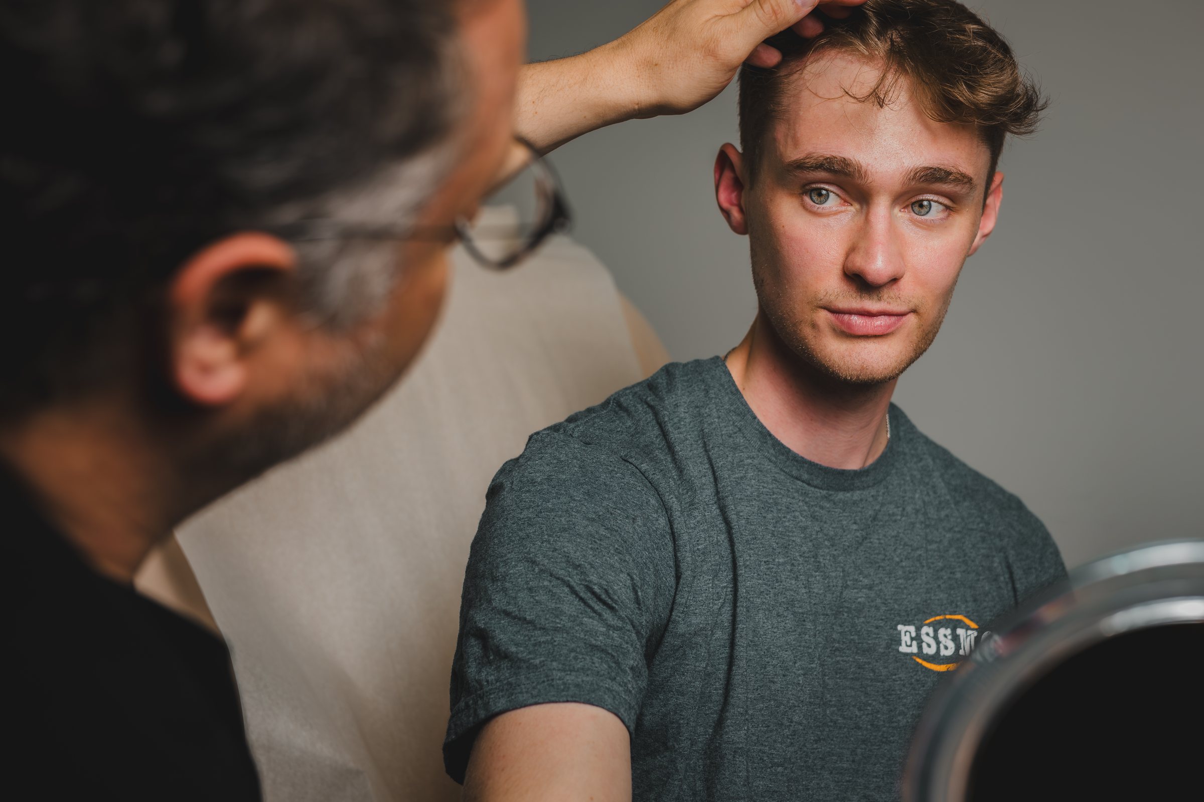 Dr. Heil checking a patient's hairline before a transplant consultation