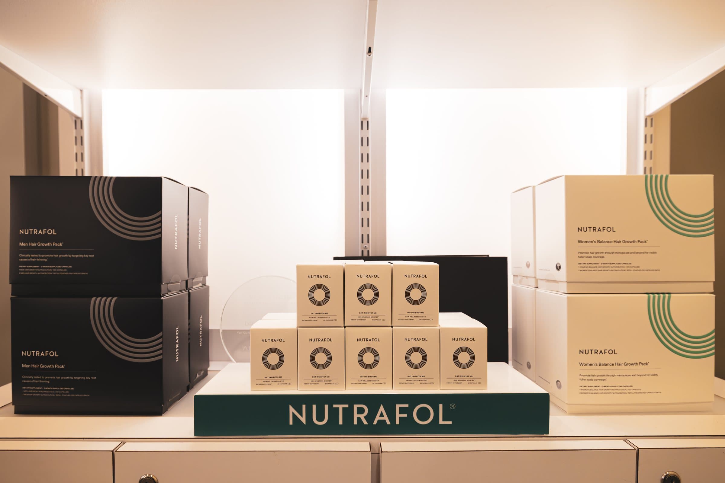 A shelf of Nutrafol hair growth supplements at the practice