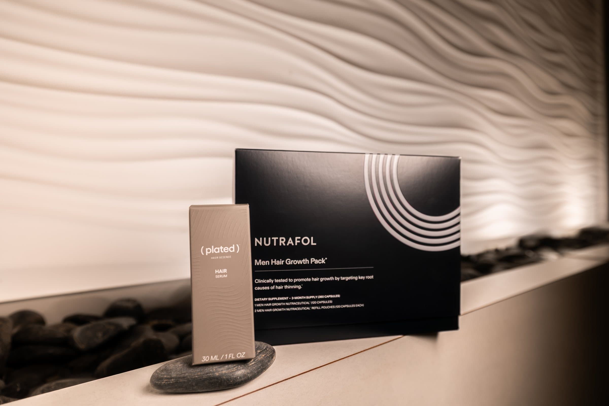 A Plated Skin Science box beside a Nutrafol Men hair growth pack