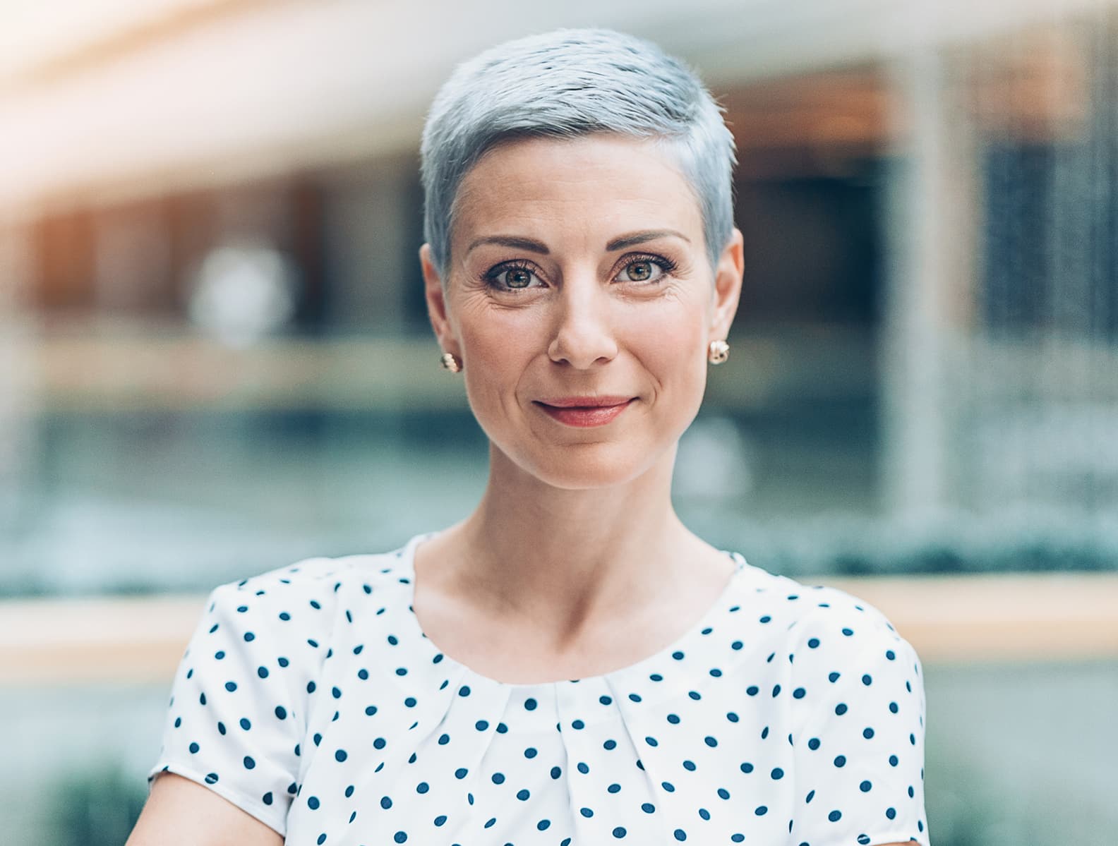 A woman with cropped gray hair and a firm, lifted profile