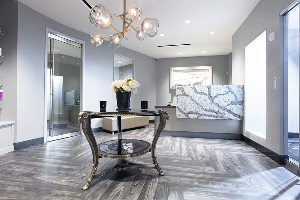 Reception in Upper St. Clair, with a marble table and sculptural chandelier