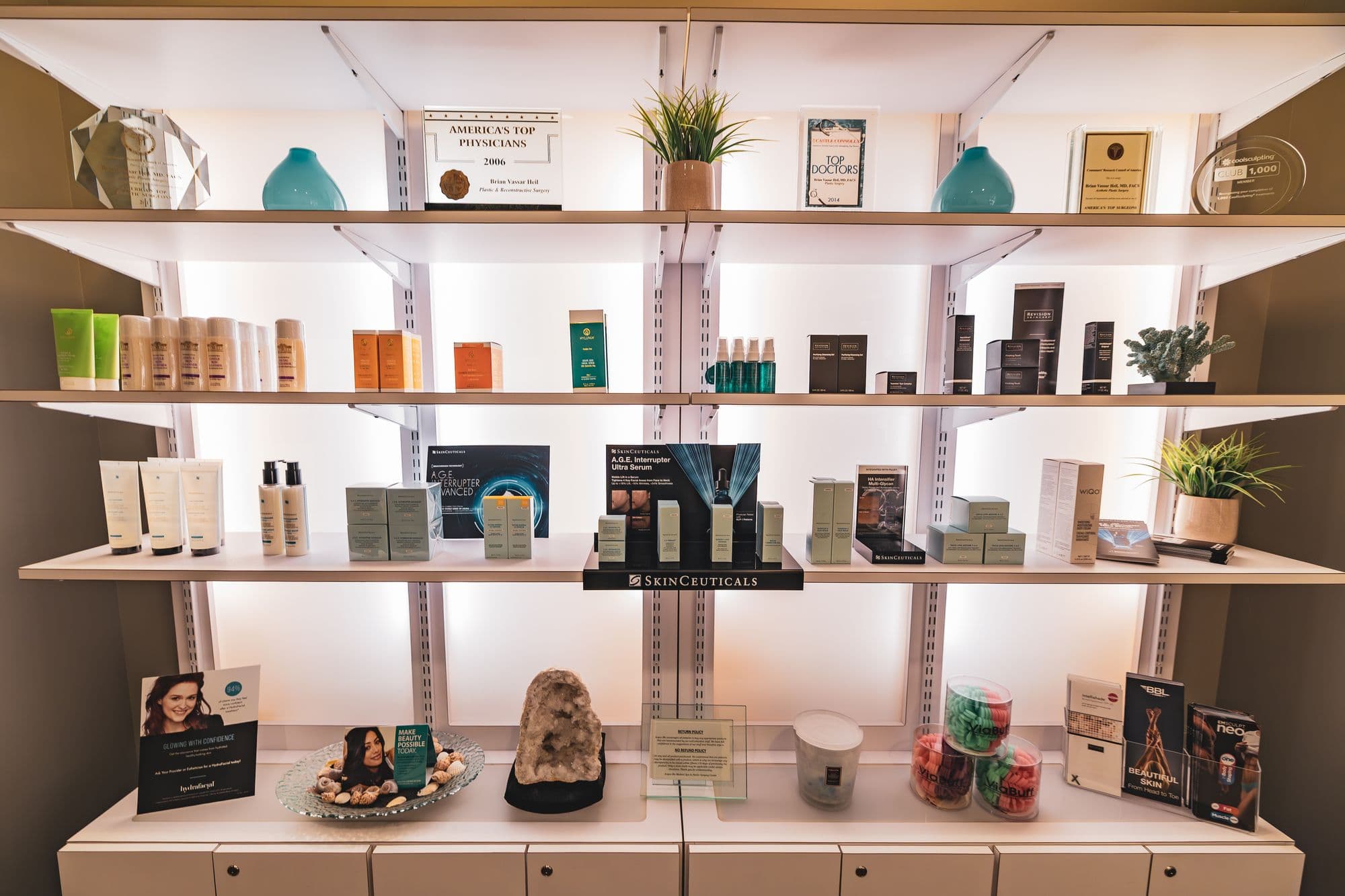 The backlit skincare wall at Acqua Blu Medical Spa