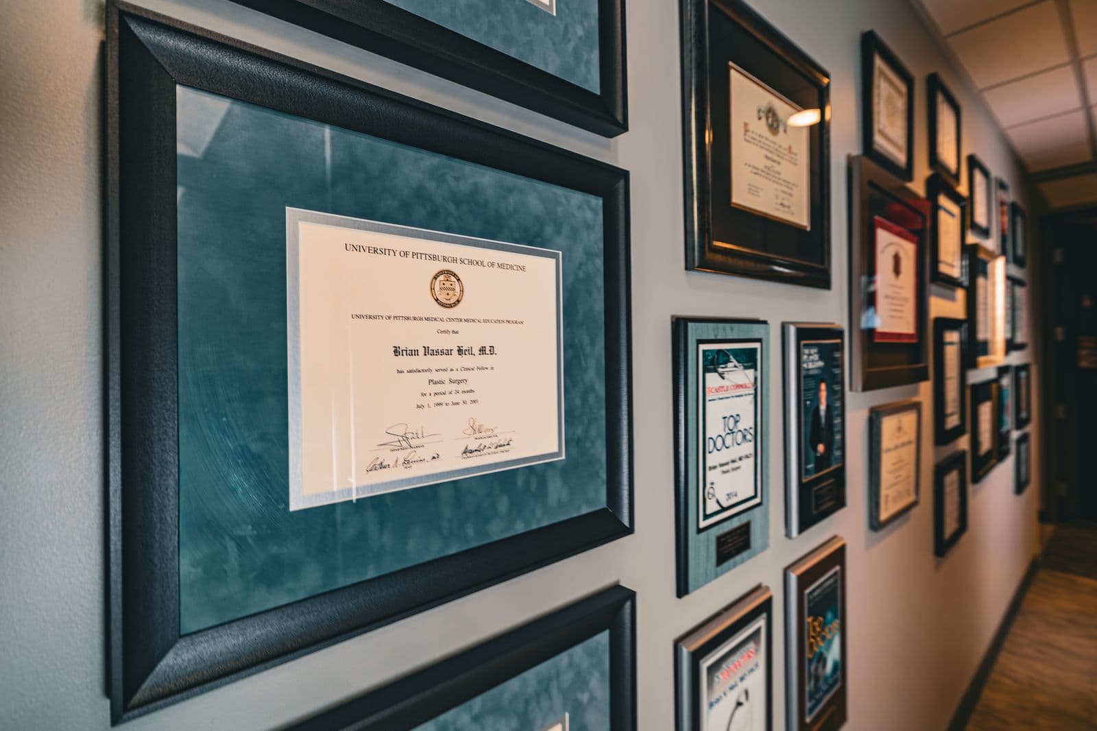 Dr. Heil's diplomas and awards along a Wexford corridor