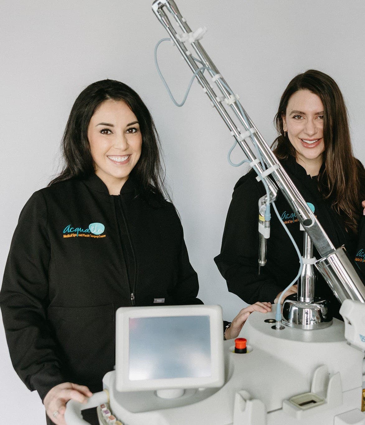 Anna and Kayla, the practice's laser specialists, at the CO2 laser console