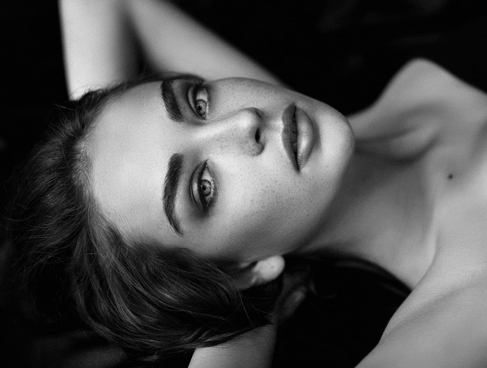A woman resting, photographed in black and white