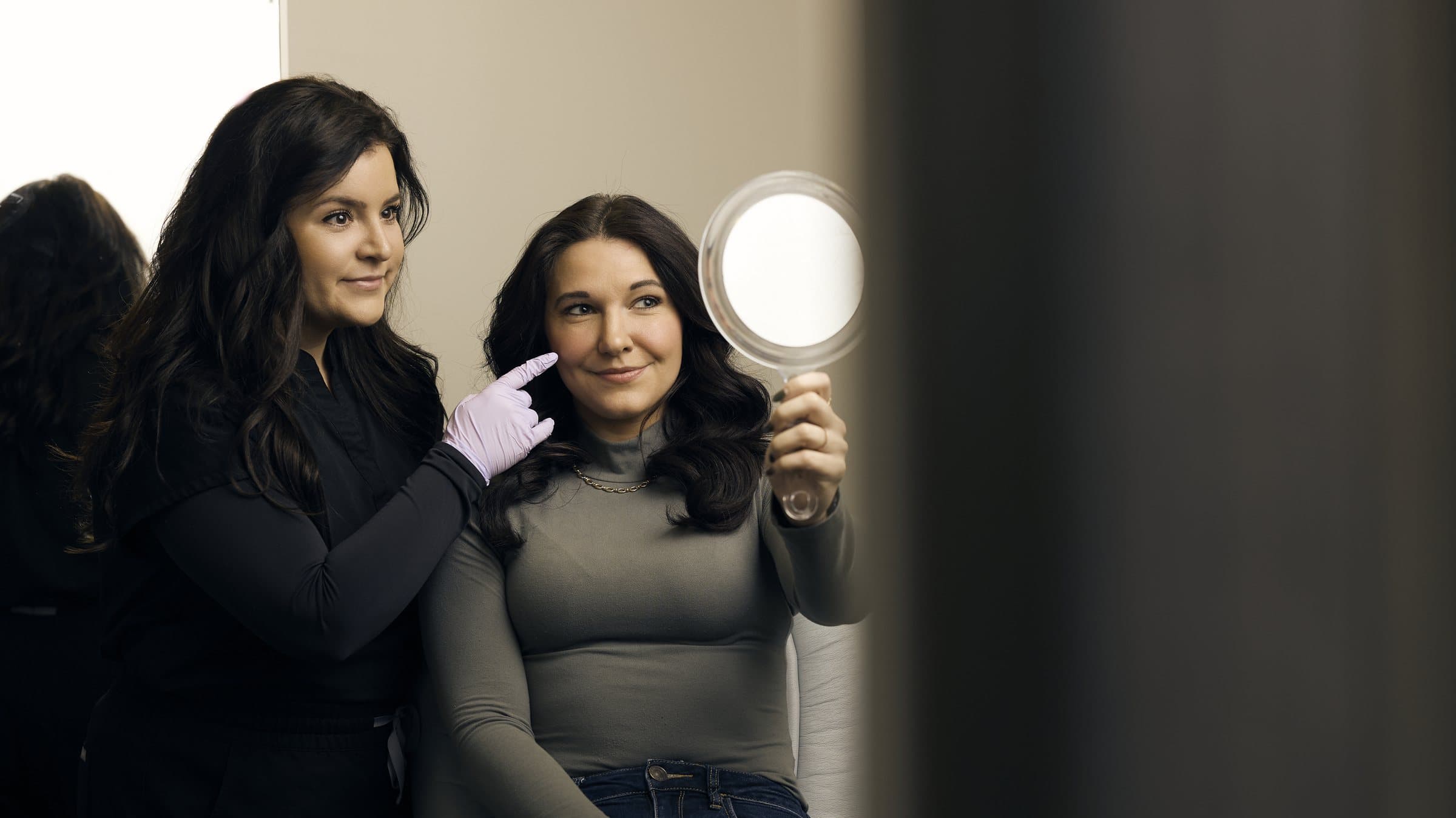Carey Steinmetz, PA-C, reviewing a treatment plan with a patient in the mirror