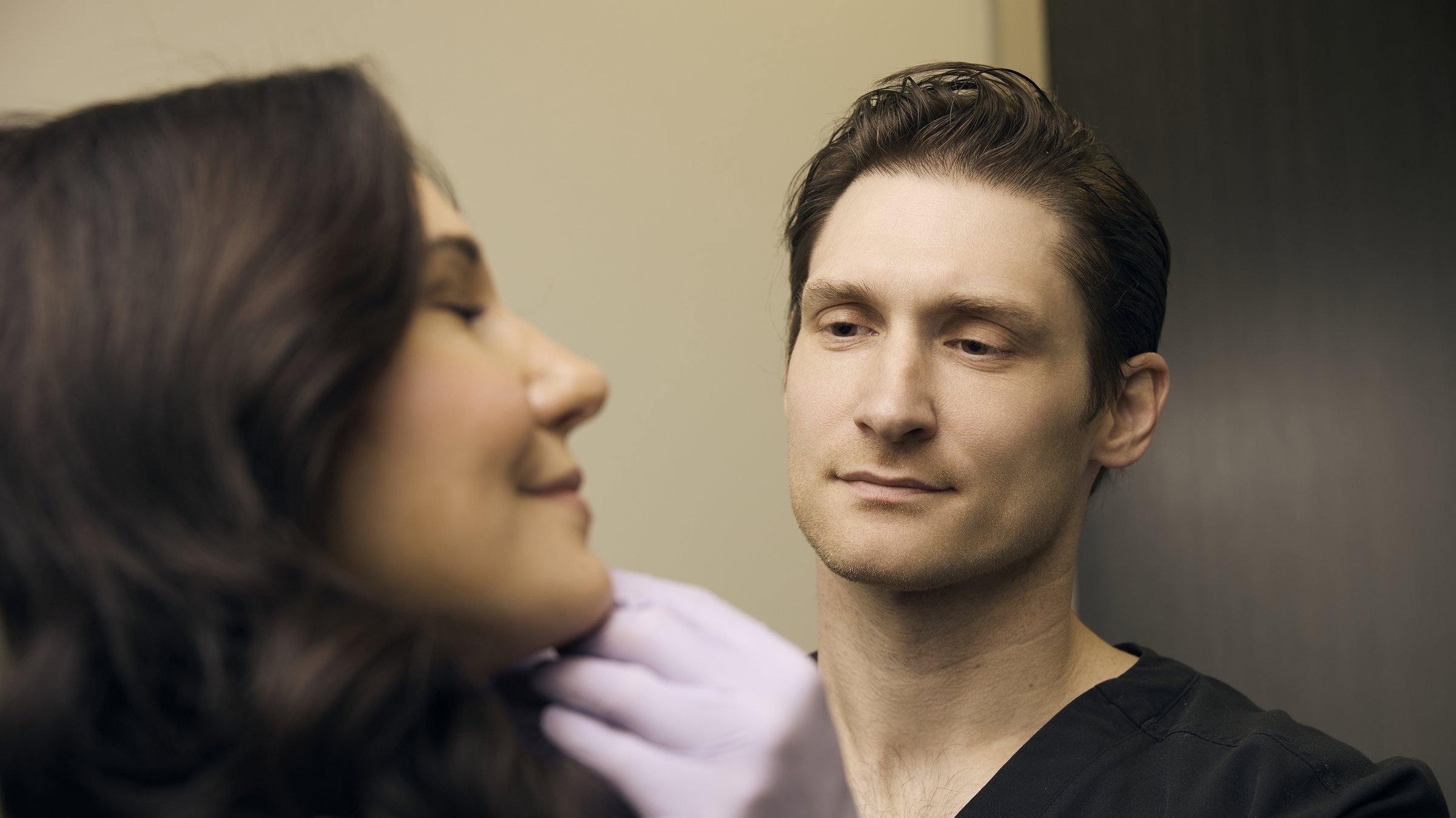 Zakery Koban, PA-C, assessing a patient before an injectable treatment