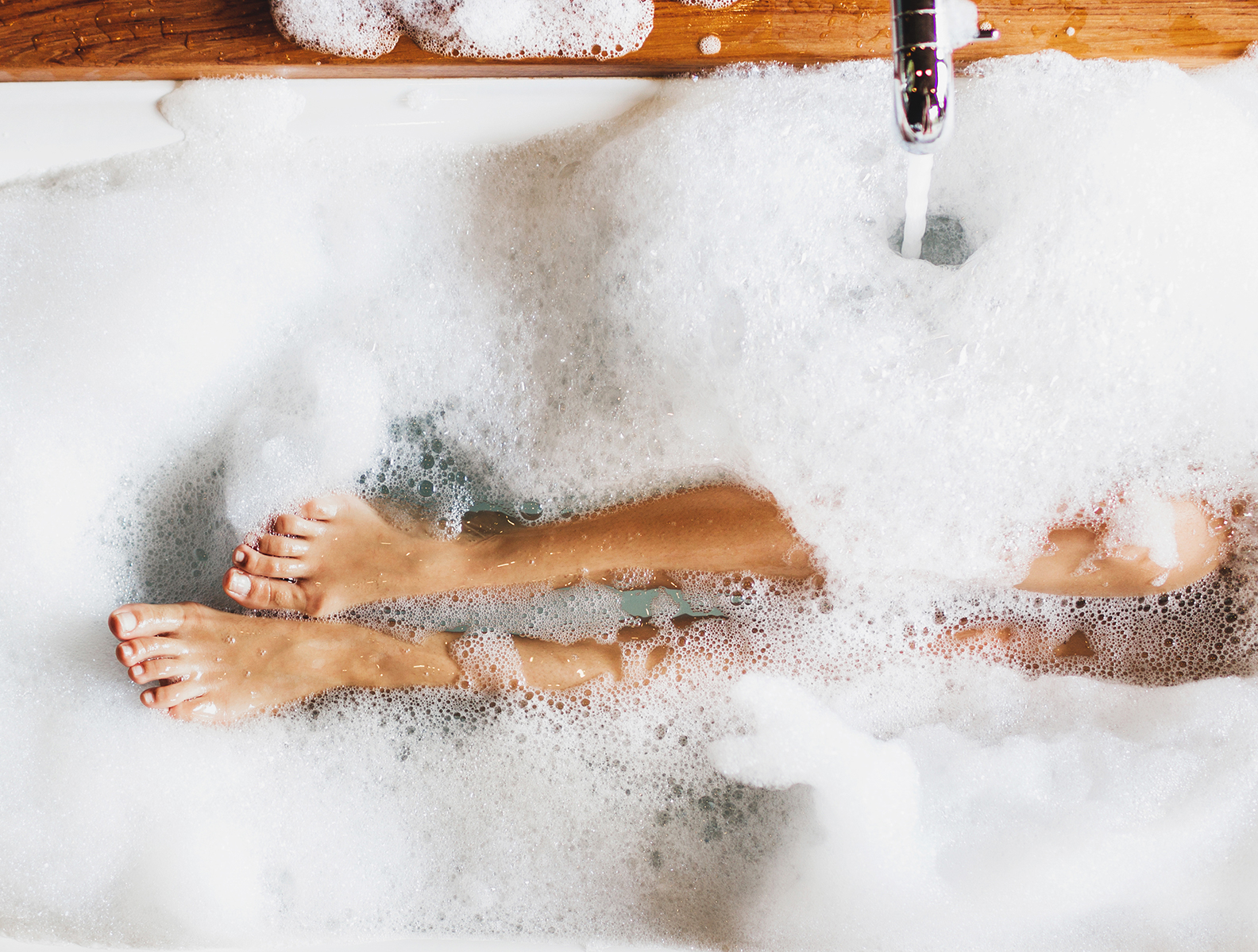 Female's feet in a bubble bath